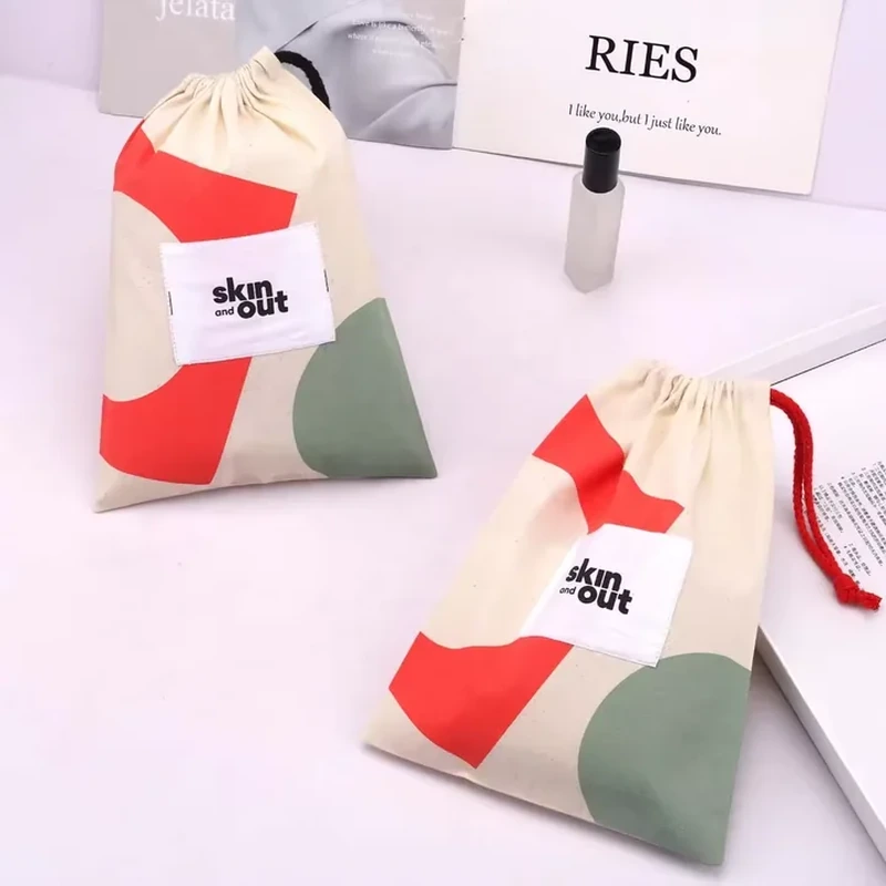 A pale drawstring pouch combines red, green and pink abstract color blocks across its body