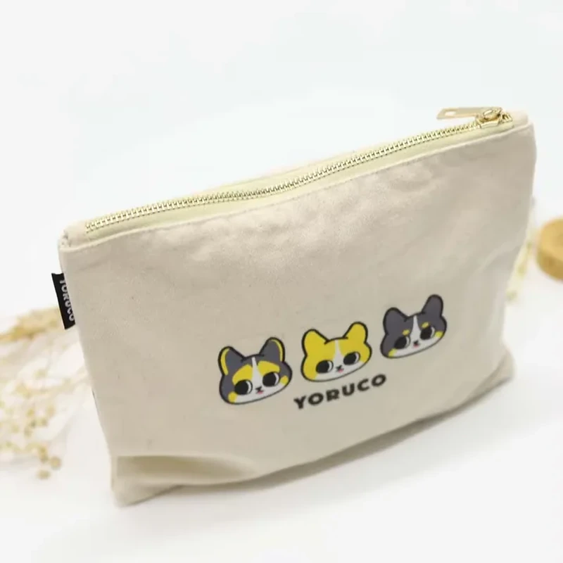 A cream zipper pouch has a broad base and a row of colorful animal faces