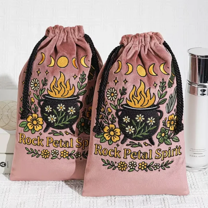 A moon-phase and botanical illustration spans the front of this tall drawstring pouch
