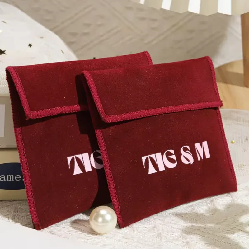 A wide rectangular flap and visible binding frame this upright foldover jewelry pocket