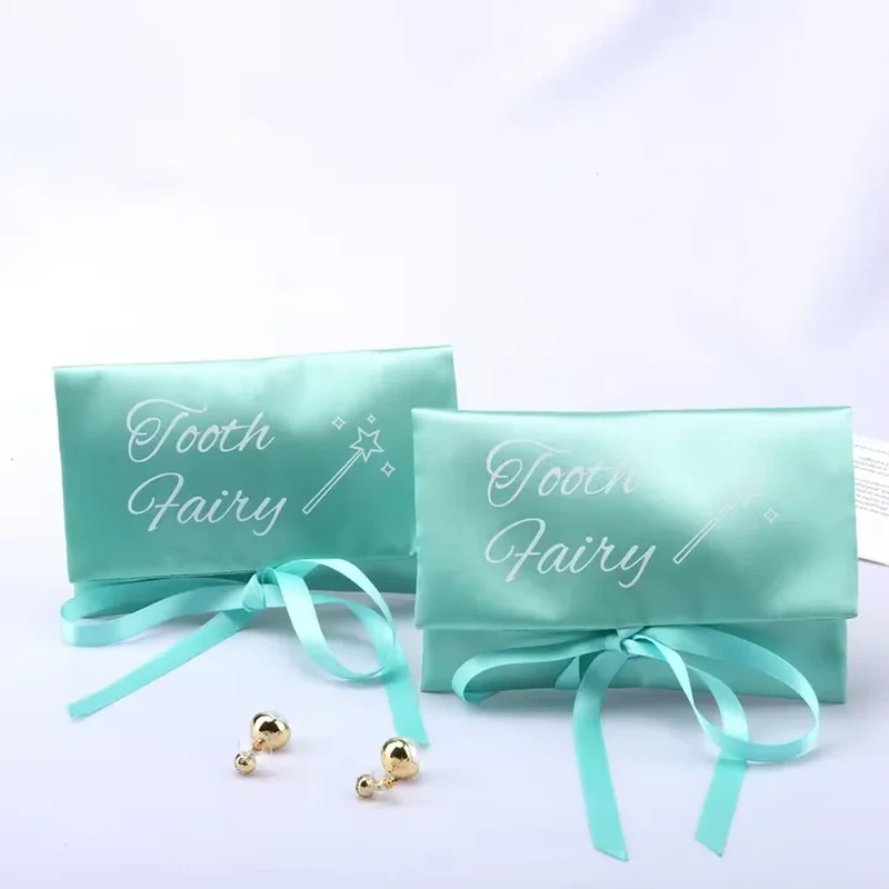 A compact rectangular satin envelope folds over and closes with a front ribbon bow