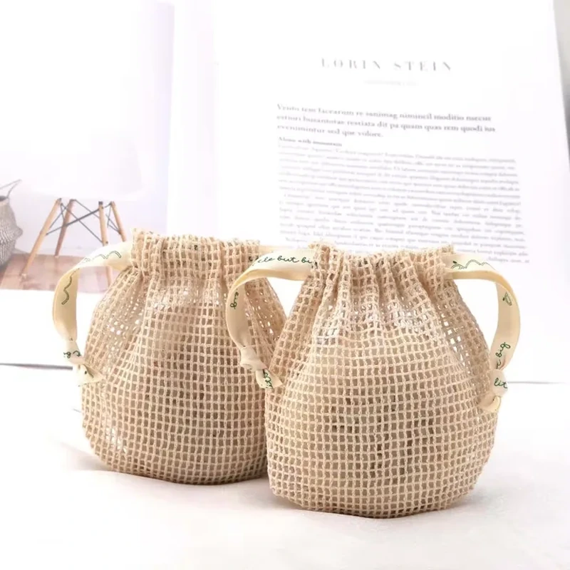 Natural open-mesh bucket-shaped pouches with gathered openings and cream ribbon ties