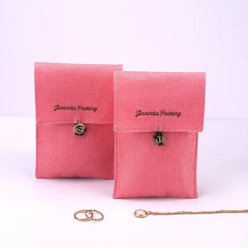 Pink woven jewelry pouches with straight flaps and small button closures
