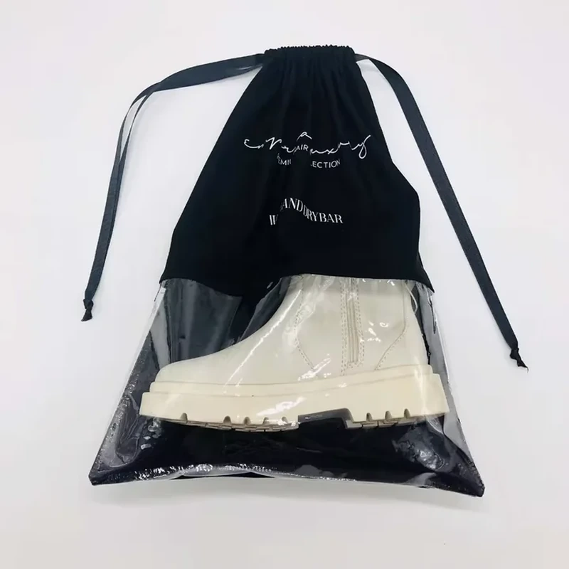 A dark drawstring bag includes a large clear lower window that reveals the packed item