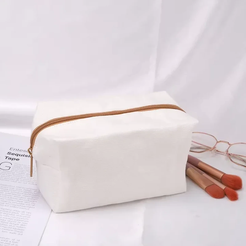 A small pale case has a box shaped body and a contrasting zipper along the top