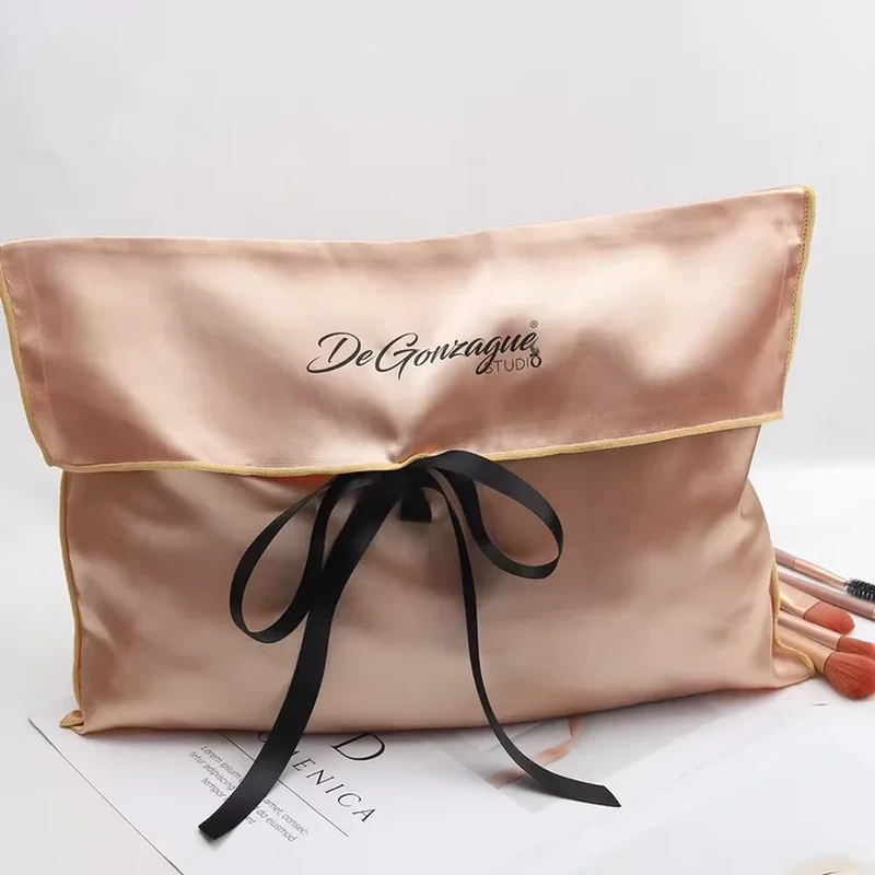 Contrast piping traces a broad satin flap above a long front ribbon bow