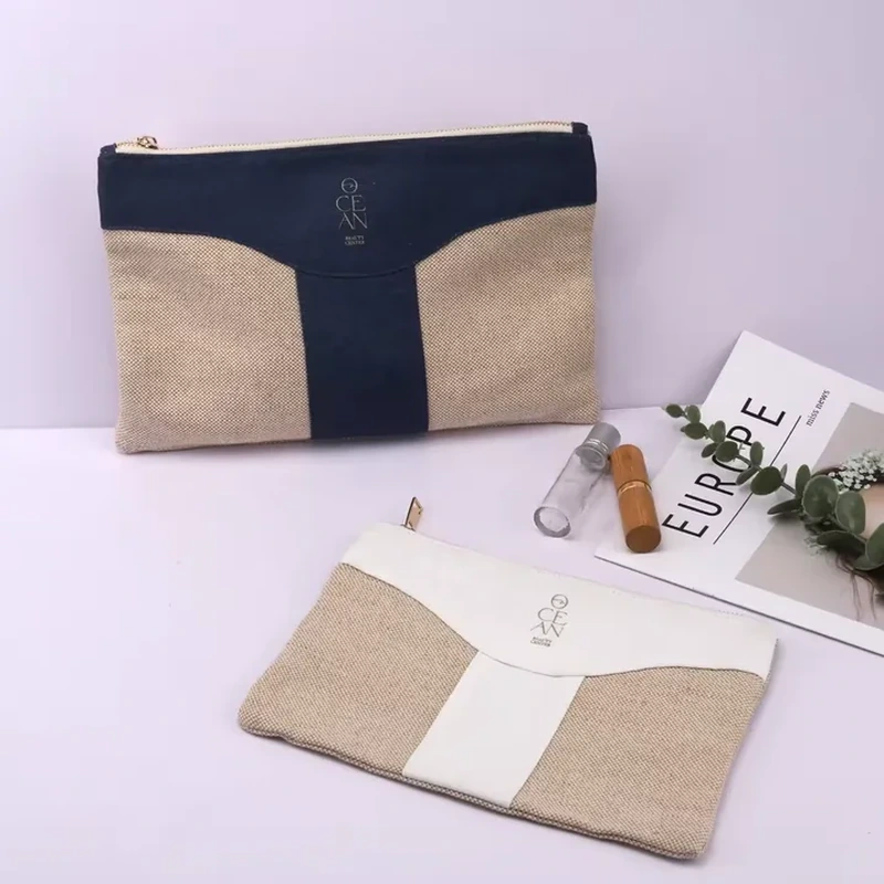 A flat zip pouch combines a natural tone body with a dark T shaped front panel
