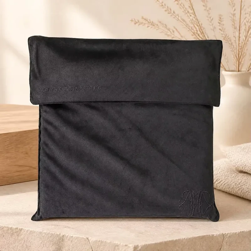 A deep straight flap folds over a tall flat sleeve with softly rounded corners