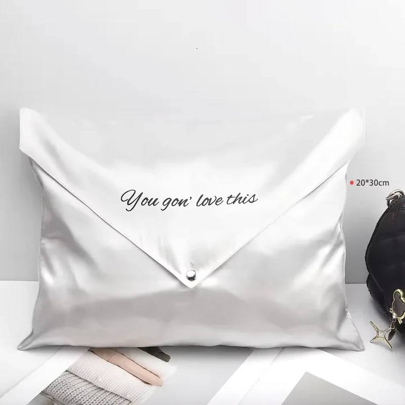 A deep pointed flap spans a wide satin envelope and fastens at its center