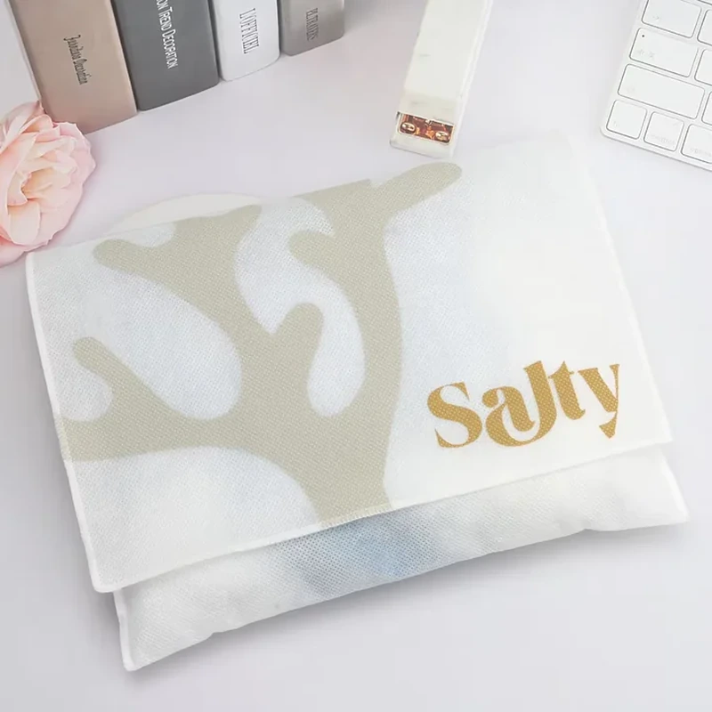 White fine-mesh envelope with broad foldover flap and a large pale coral-shaped print