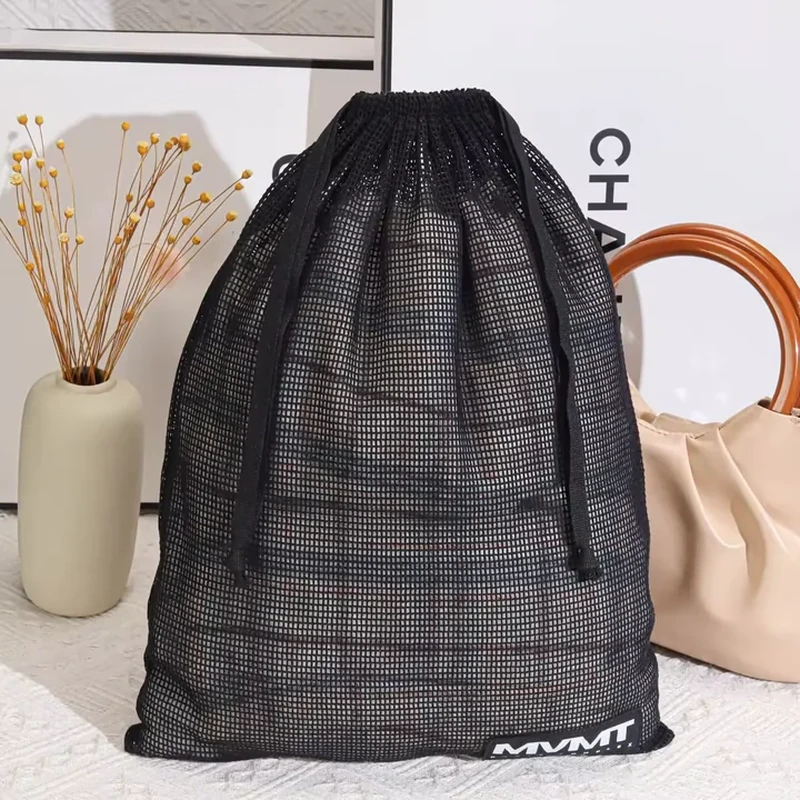 Tall black fine-mesh drawstring storage sack with a small lower-edge label