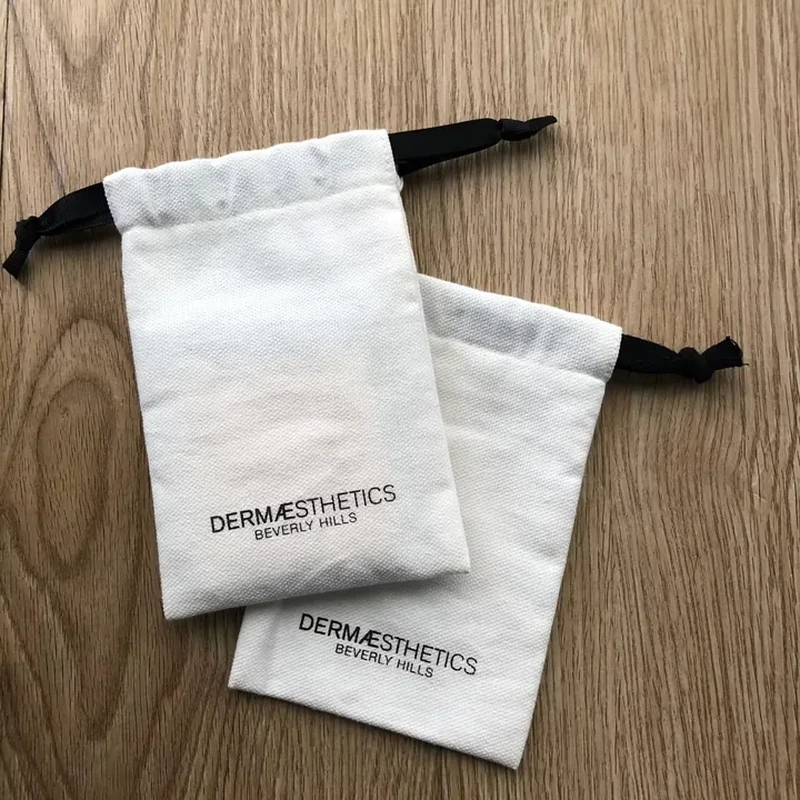 A flat pale sleeve has a straight top channel and contrasting dark ribbon ends