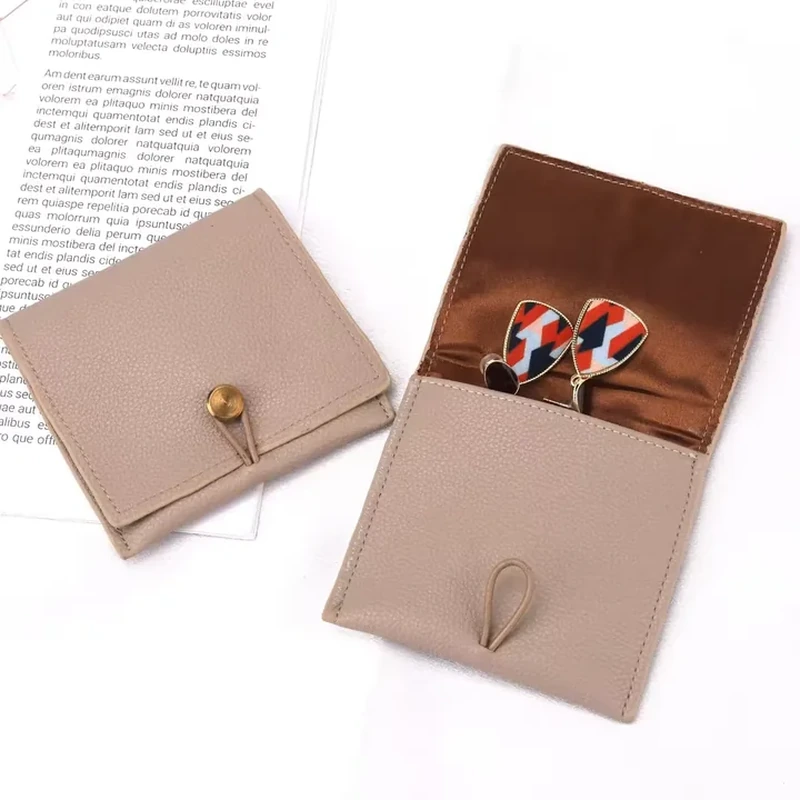 Taupe foldout leather-look wallet with interior pocket and loop fastening