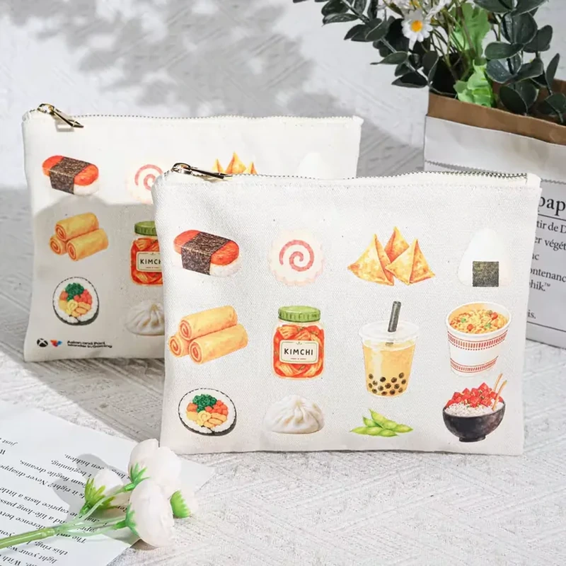 A pale flat zipper pouch is covered with small colorful food and drink illustrations