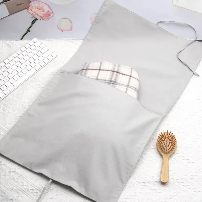 Gray fabric sleeve opened to show its extended full-length flap and folded contents