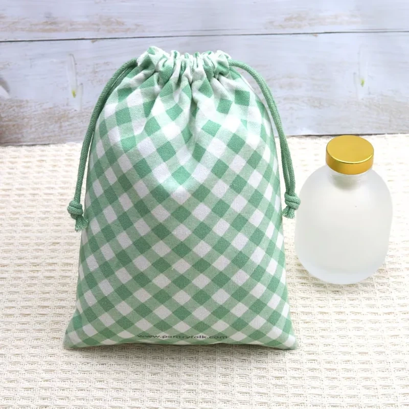 A gathered sack displays a green and white gingham check across its entire body