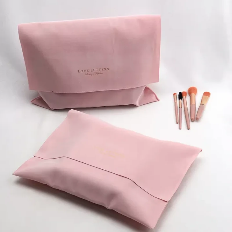 Boxed lower corners support a wide beauty pouch with a softly curved top flap