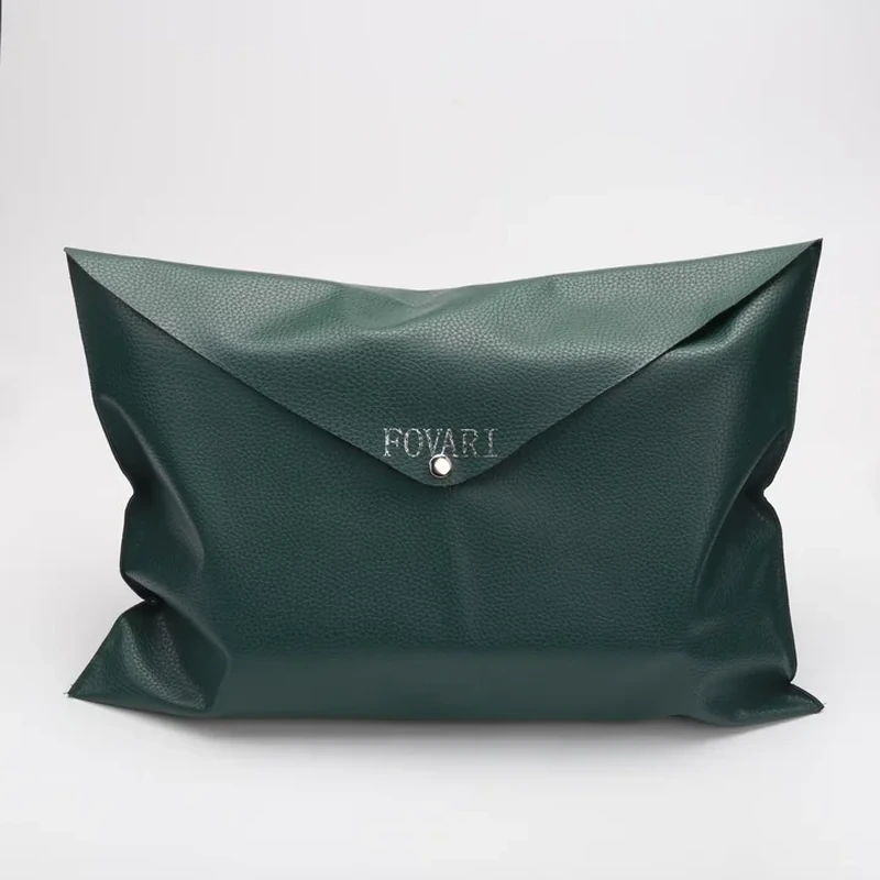 Dark green leather-look envelope bag with triangular flap and folded side gussets