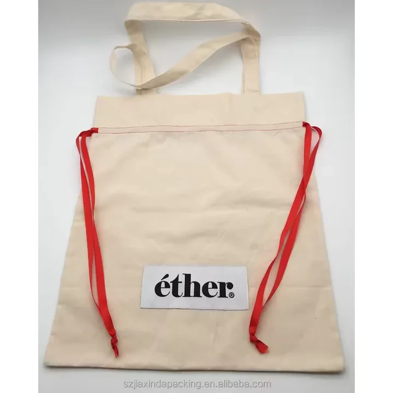 A pale tote combines fabric carrying handles with contrasting red drawstrings down its sides