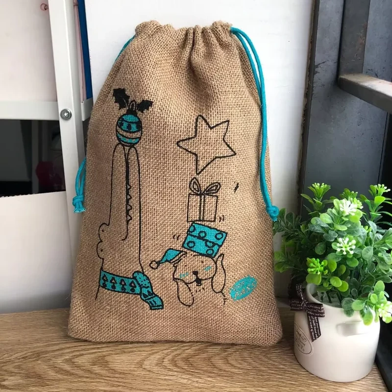 Tall natural woven gift bag with blue cords and illustrated artwork