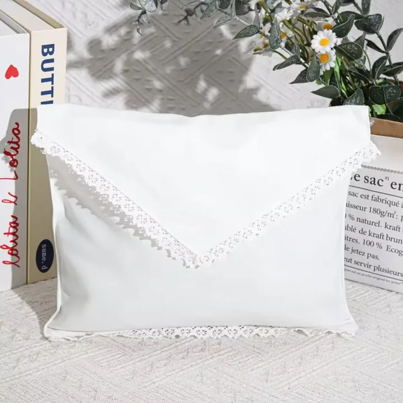 A pale envelope style pouch has decorative lace following its pointed front flap
