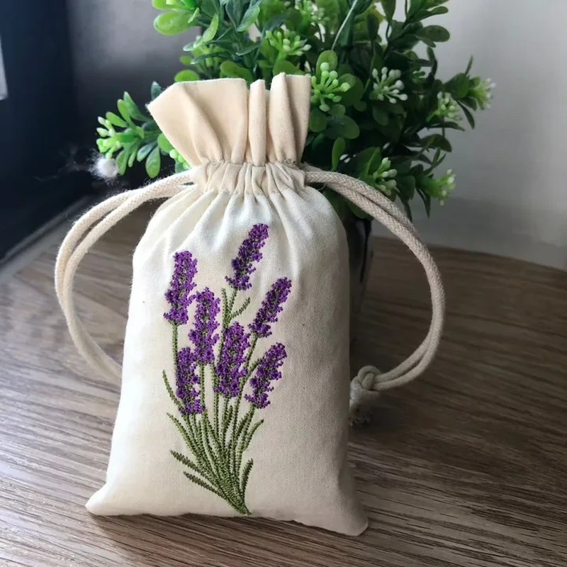 A natural tone drawstring sachet carries a tall lavender illustration beneath its gathered neck