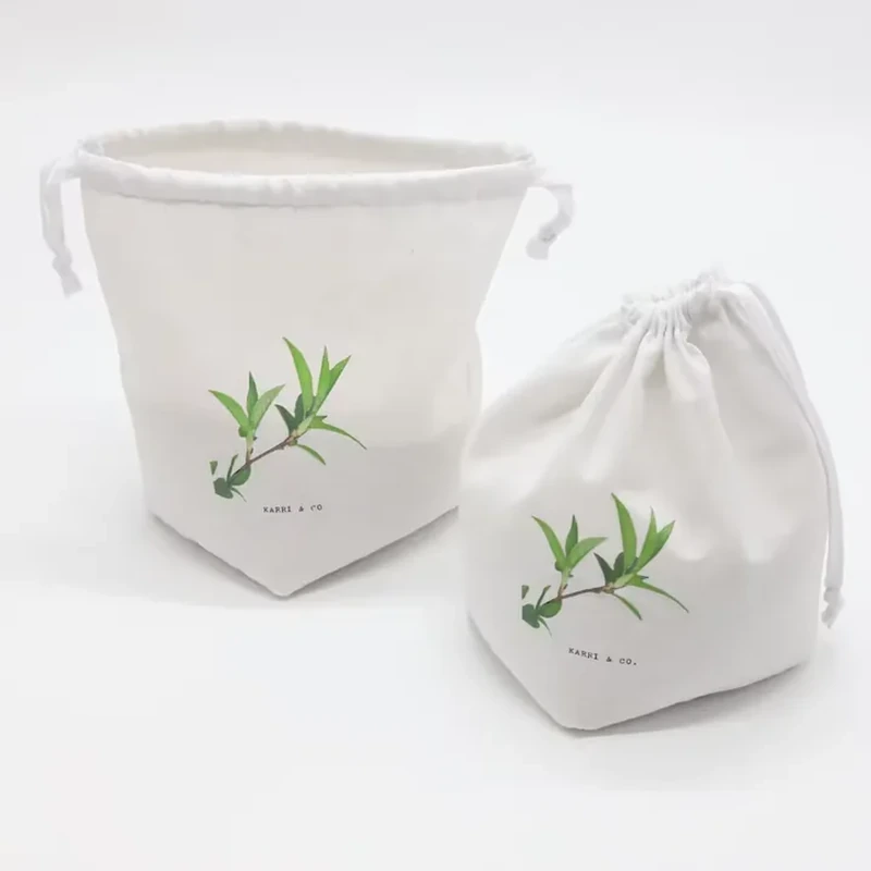 A pale gusseted pouch displays a small leafy sprig and a gathered cord opening