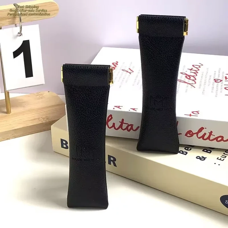 Long black leather-look accessory sleeves with straight tops and metal end details