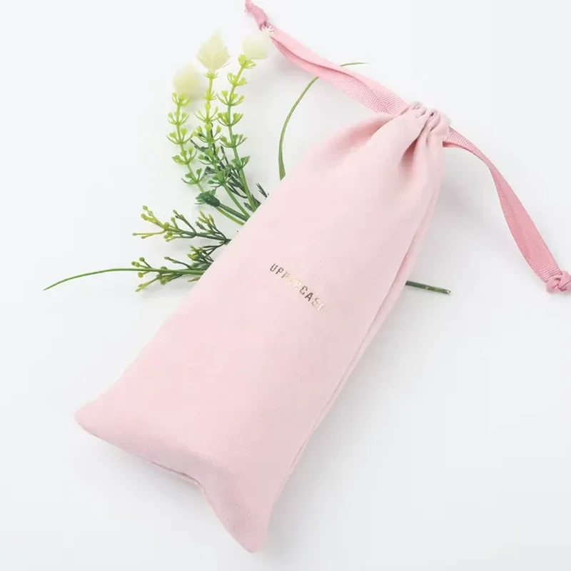 An elongated sleeve has a softly pointed base and ribbon ties at its neck