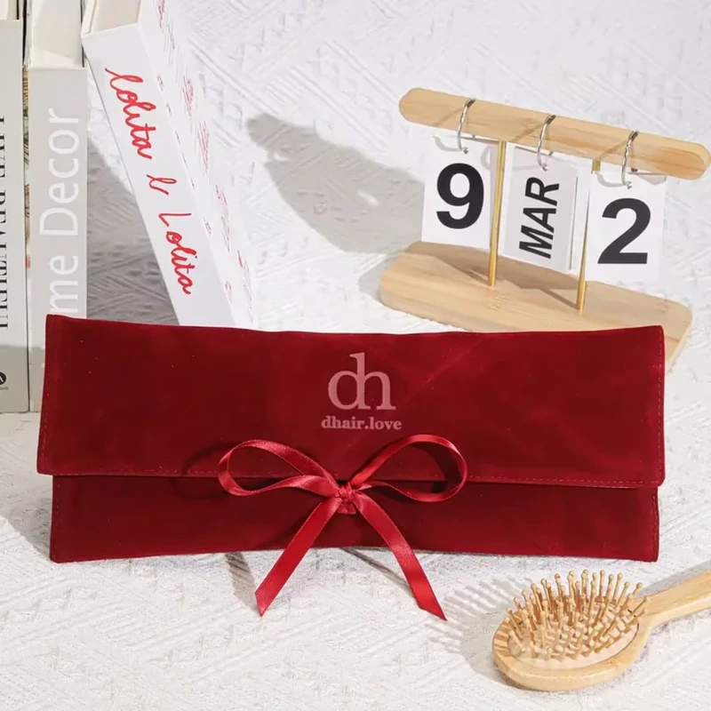 An elongated horizontal envelope has a broad flap and a narrow central ribbon bow