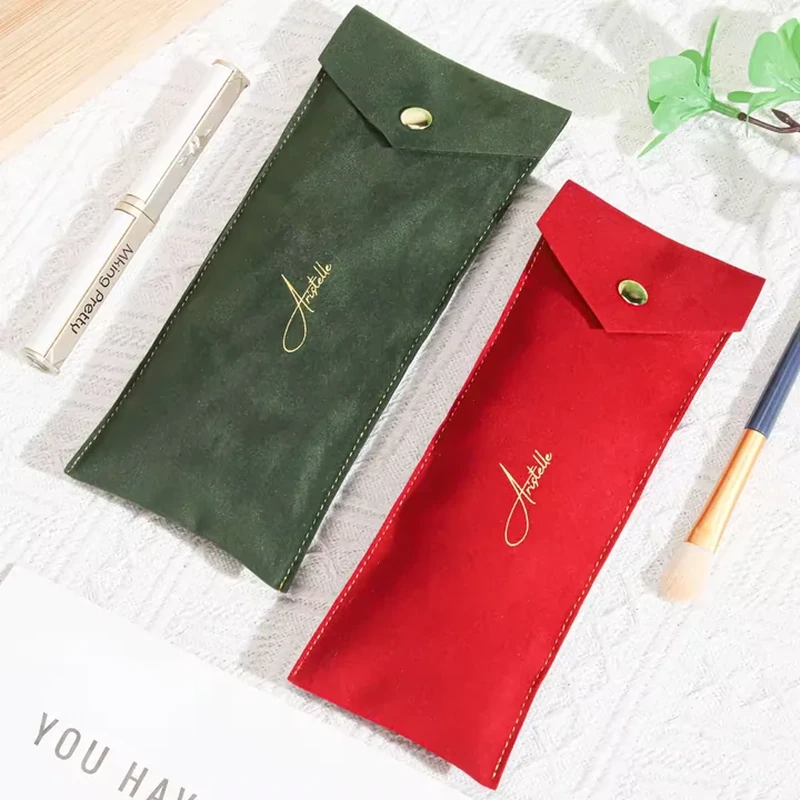 A very slim rectangular sleeve closes with a short angled flap and metal snap