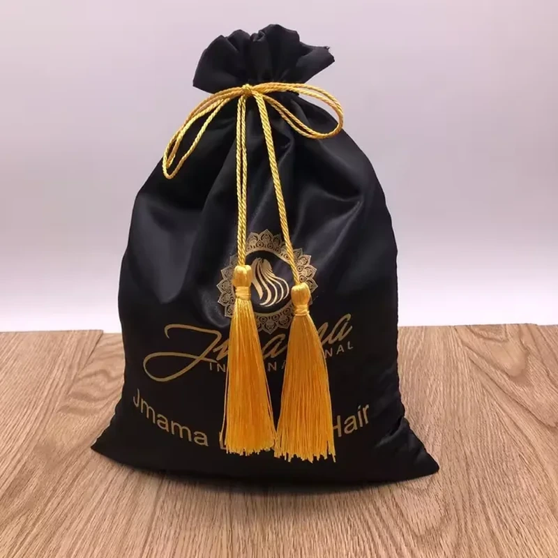 Long decorative tassels hang from a cord bow around the neck of a satin bag