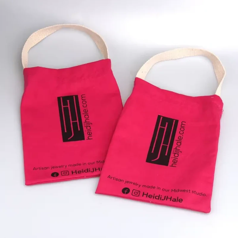 A flat red sleeve has a pale loop handle above its straight top opening