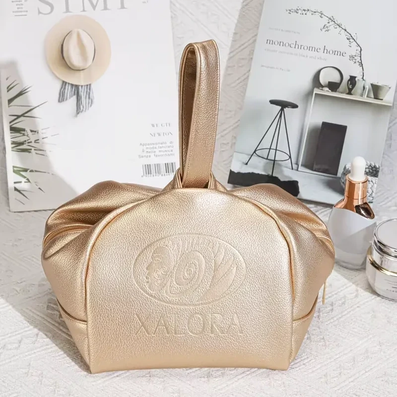 Gold leather-look vanity bag with top handle loop and gathered side panels