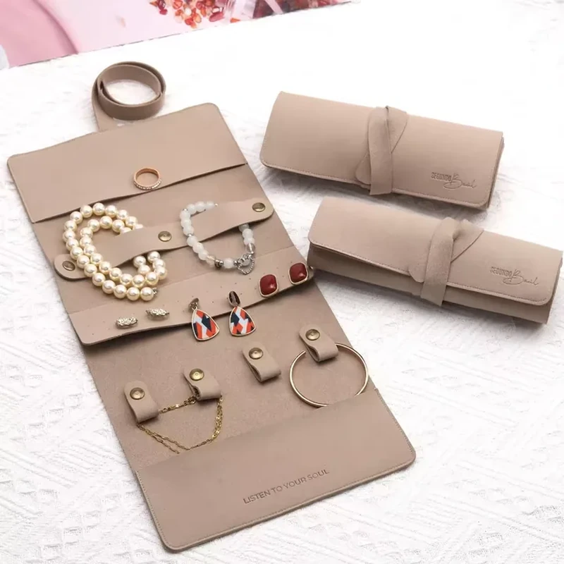 An extended folding roll displays jewelry on several panels with snap tabs and loops