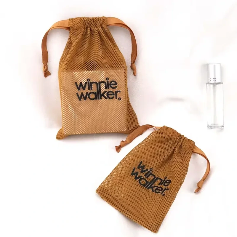 Tall ochre mesh accessory sleeves with ribbon ties and dark printed lettering