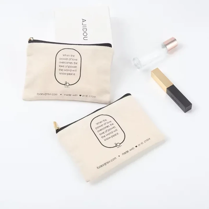 A flat cream zip pouch shows a dark zipper and a framed front label design