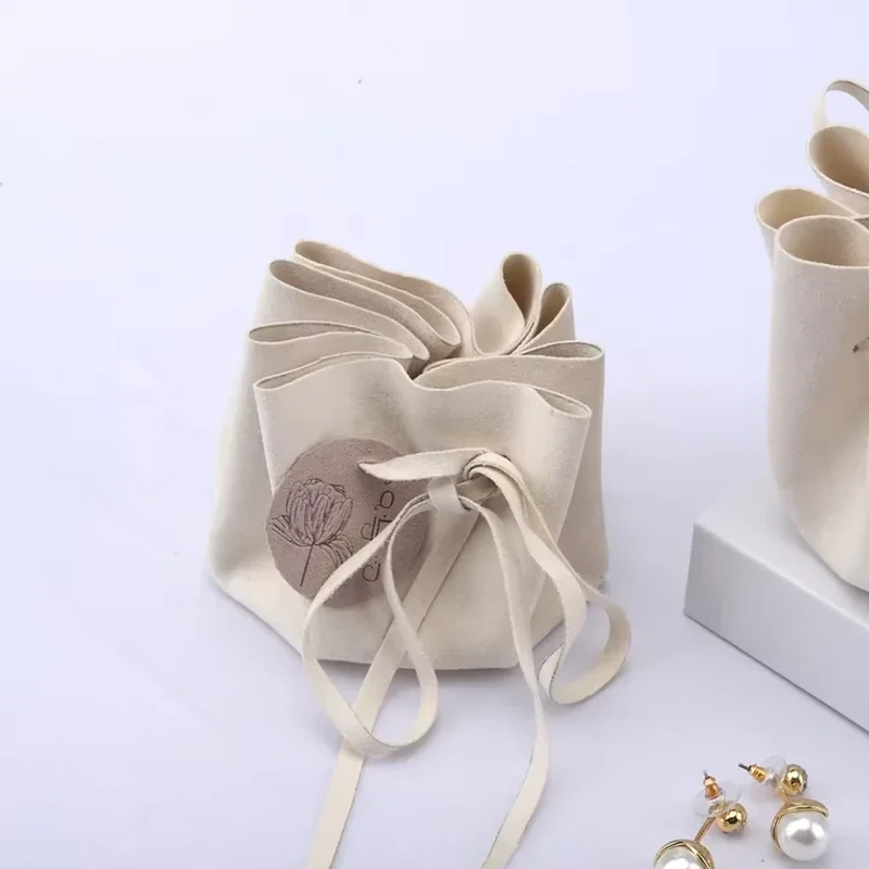 Overlapping fabric folds form an open petal shape above a front cord tie