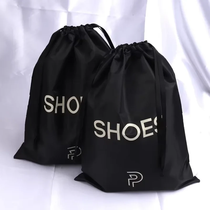 Black drawstring shoe sacks with large contrasting shoe lettering on the front