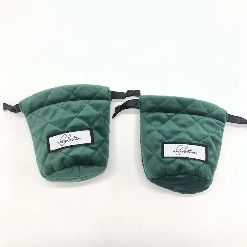 Diamond stitching, a rounded base and a sewn front label distinguish this pouch