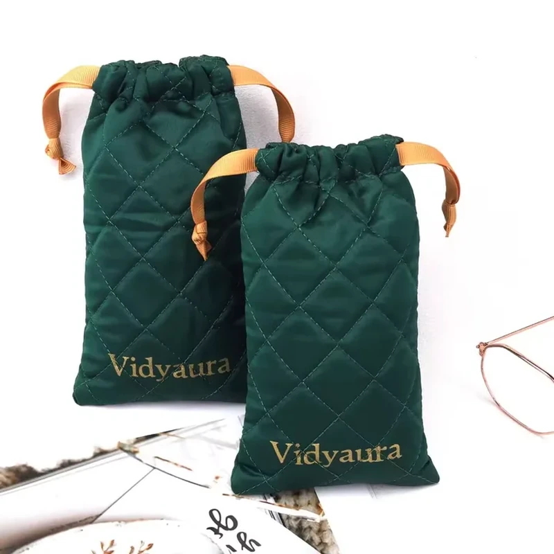 Diamond quilting runs down a tall drawstring sleeve with wide contrasting ribbon ties
