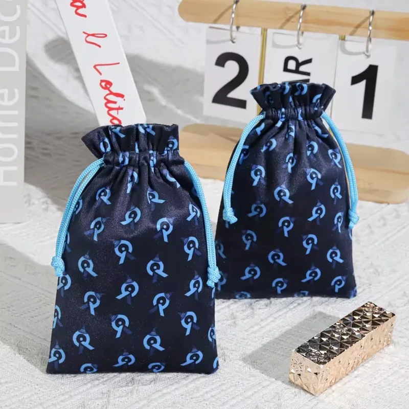 A repeated contrasting motif covers a tall gathered pouch with matching cord ties