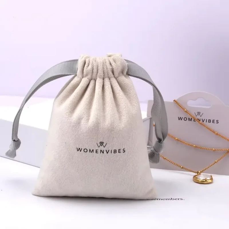 Broad ribbon loops frame a softly tapered pouch with a tightly gathered top