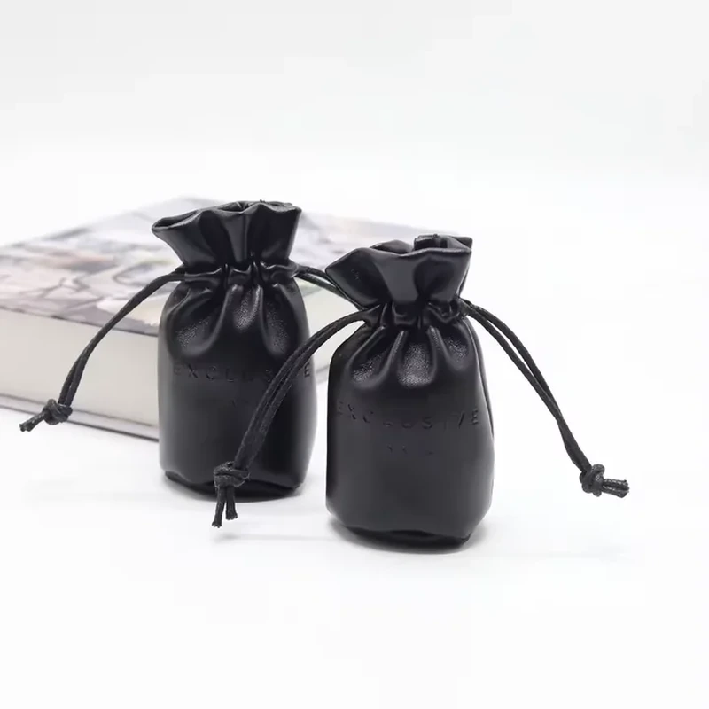 Glossy black round-base leather-look pouches with flared drawstring collars