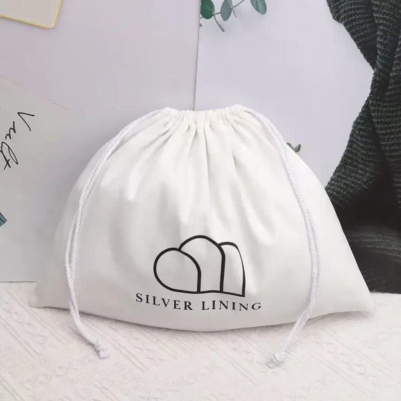 A wide pale pouch has a curved lower edge and a simple cloud line illustration