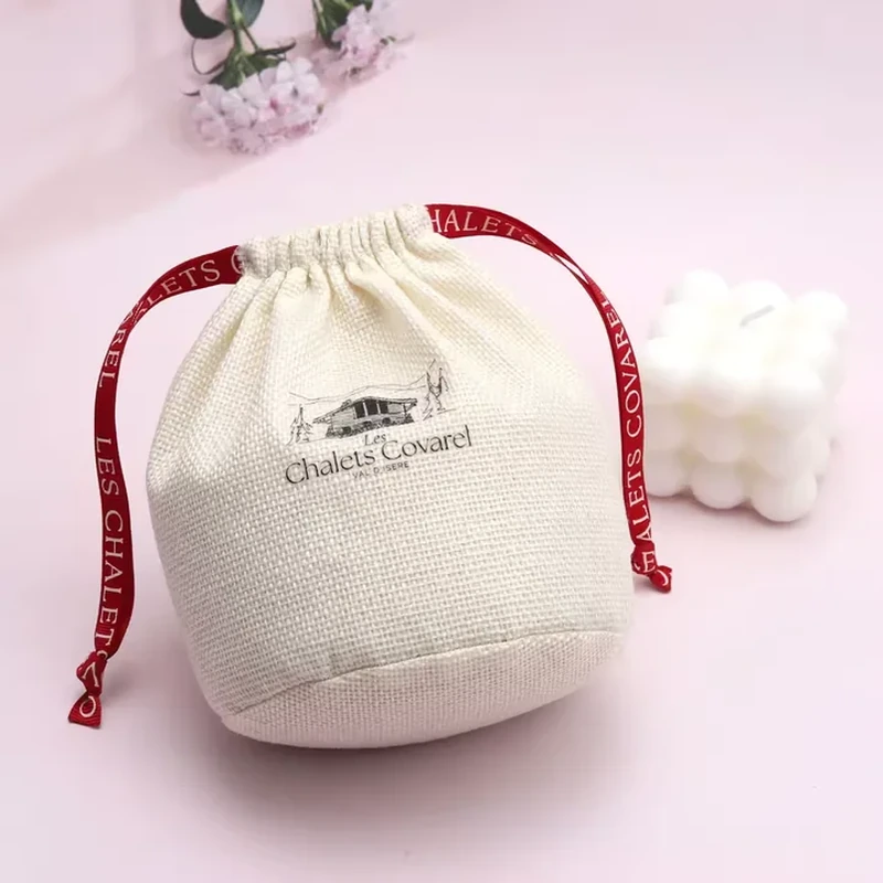 Cream woven round-base pouch with red printed ribbon ties