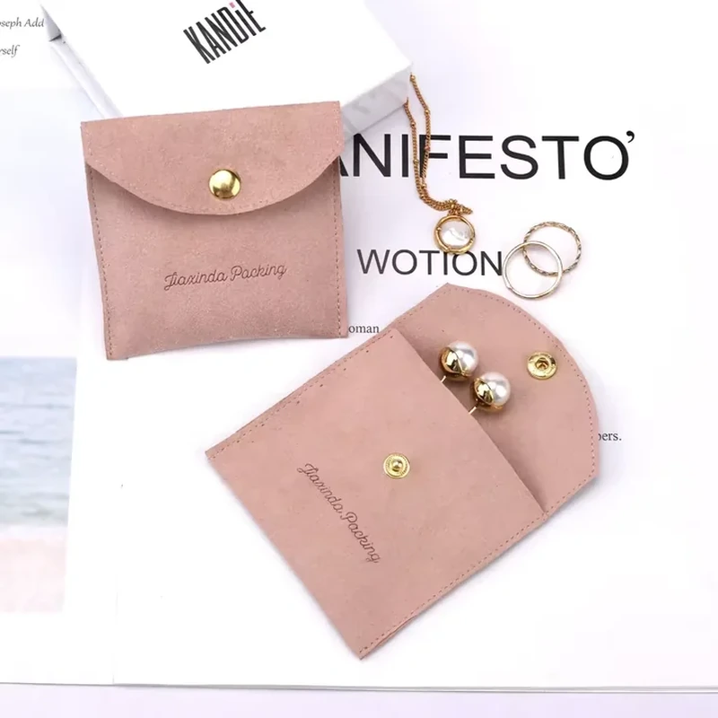 A rounded snap flap opens to a compact panel that displays paired earrings