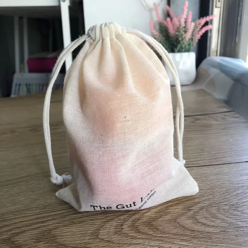 A pale gathered pouch shows a subtle pink gradient across its lower half