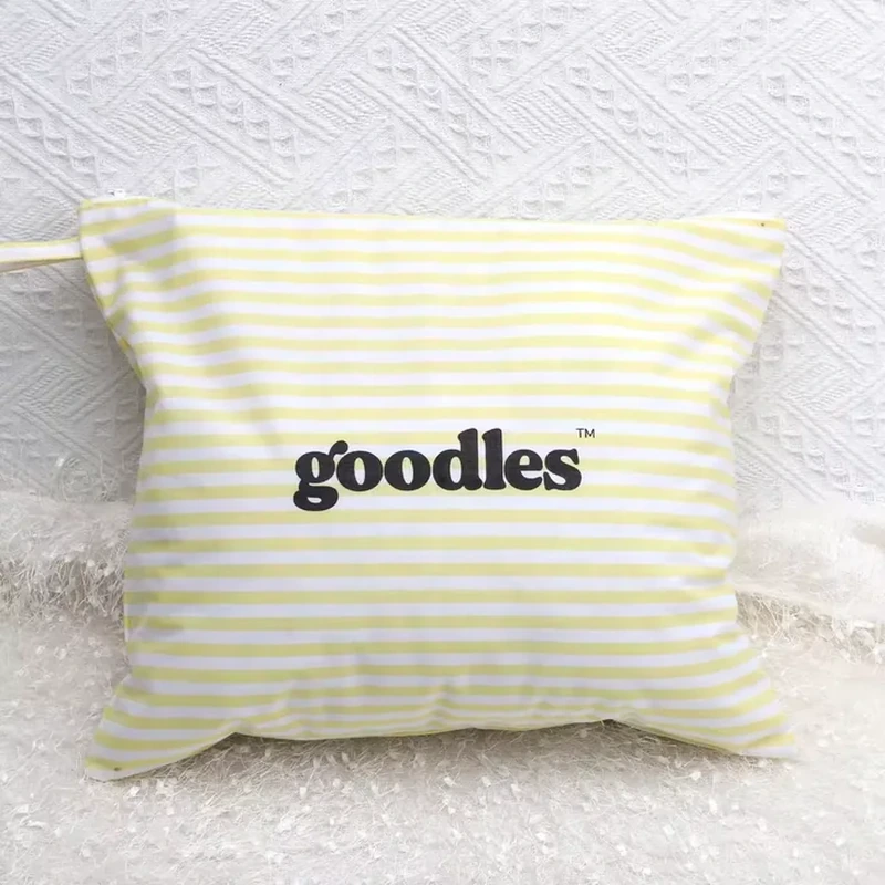 Flat pale yellow-and-white striped zipper pouch with centered dark lettering