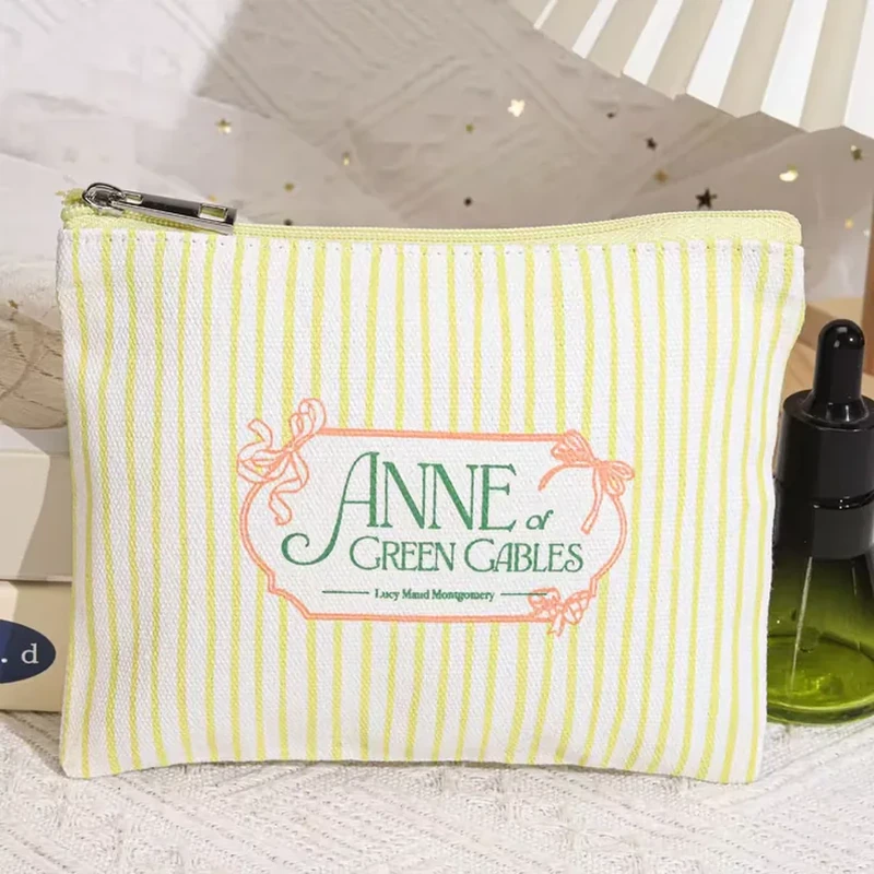 A standing zip pouch has narrow vertical stripes and a decorative framed front label